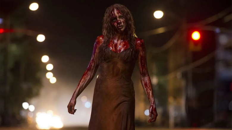 A bloody Carrie walks in the street