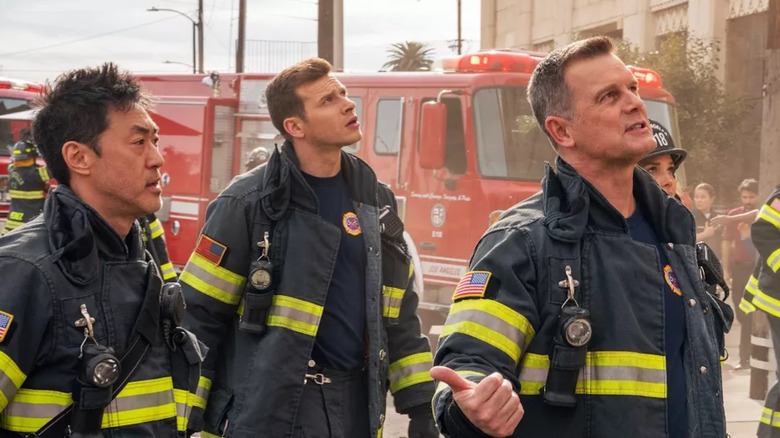 9-1-1's Chimney, Buck, and Bobby in fire gear looking up at something 