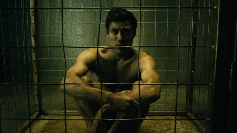 Translucent sits on the floor in a cage in The Boys TV series