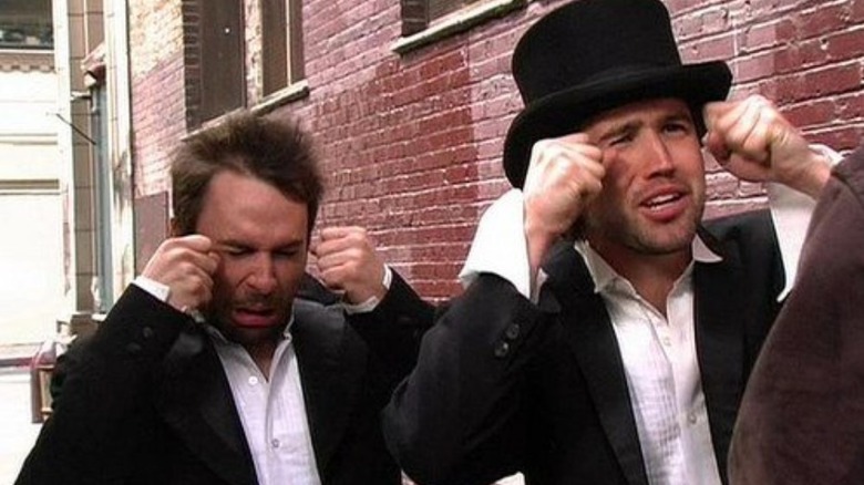 Charlie Kelly and Mac in suits make big crying gestures